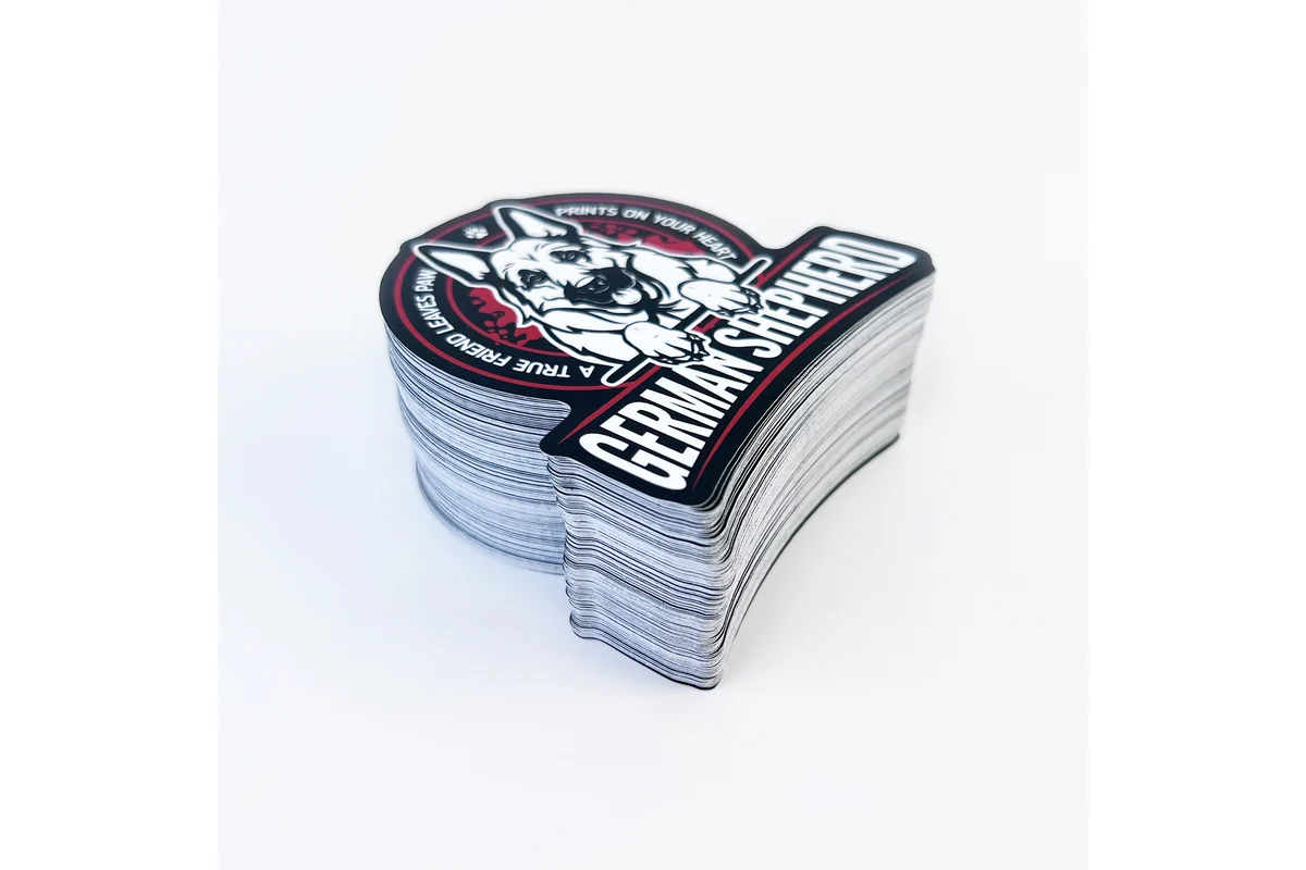 A neatly stacked set of shaped printed decals with a dog illustration.