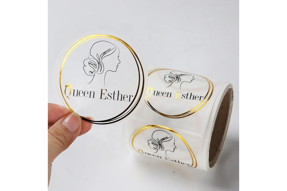 A roll of clear round labels with gold and black printing