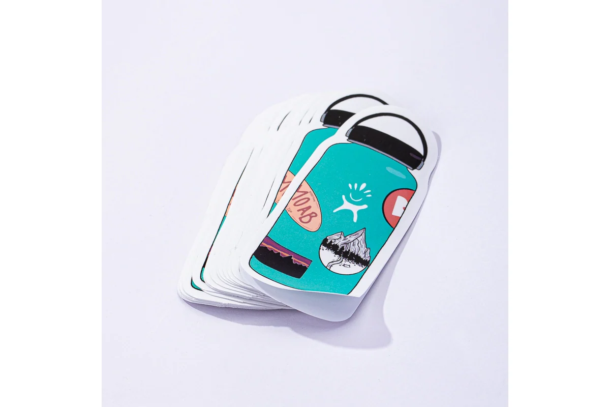 Printed bottle-shaped stickers in a neat stack