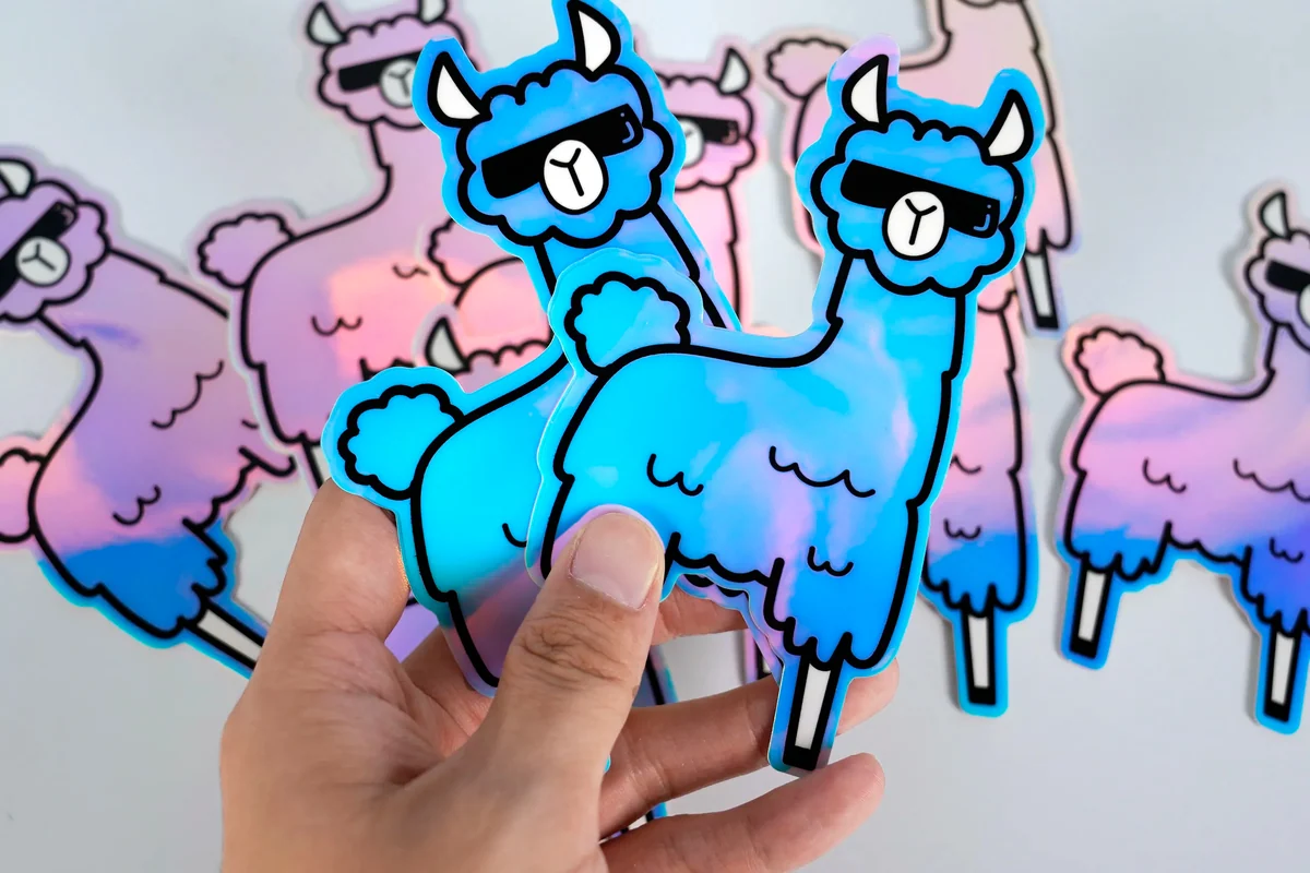 Hand holding several character-shaped stickers