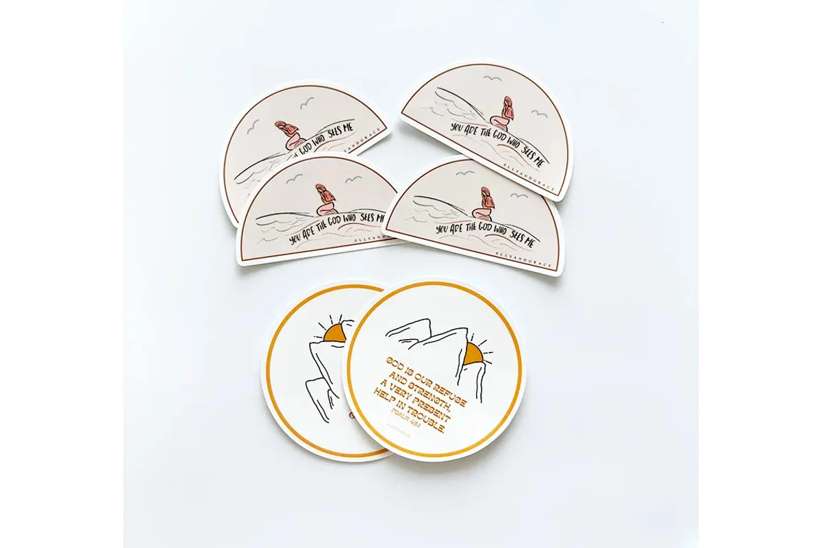 Printed semicircular and round sticker samples on a light surface