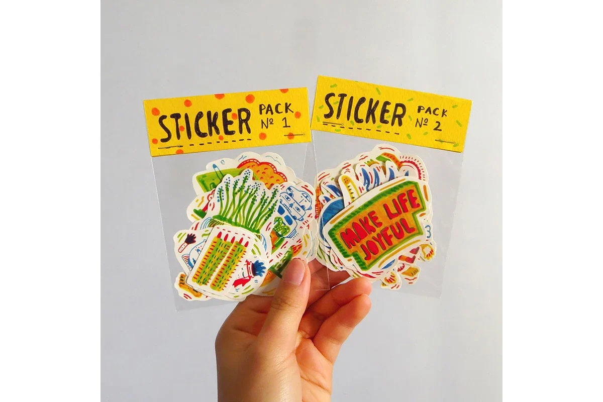 Sticker sets packed in clear bags with yellow header cards.
