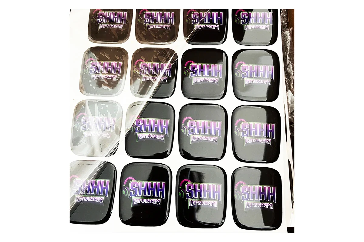 Square domed stickers arranged in rows on a sheet.