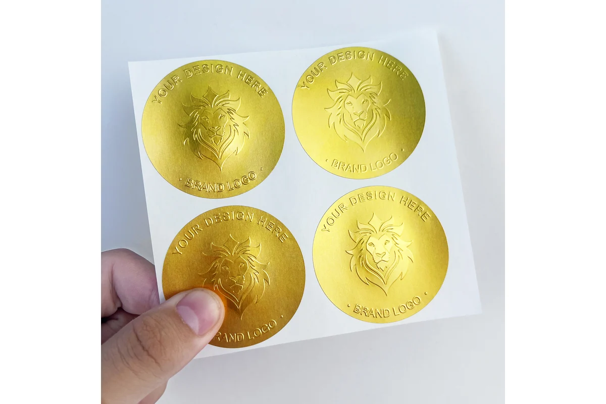 Gold embossed round label samples on backing paper