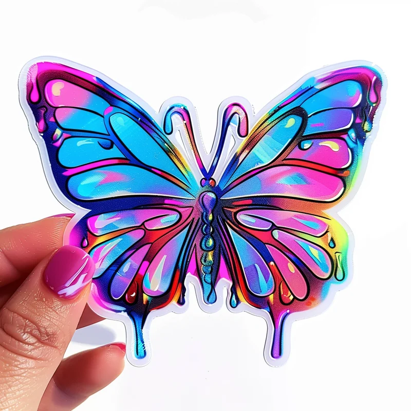 A hand holding a butterfly-shaped holographic sticker