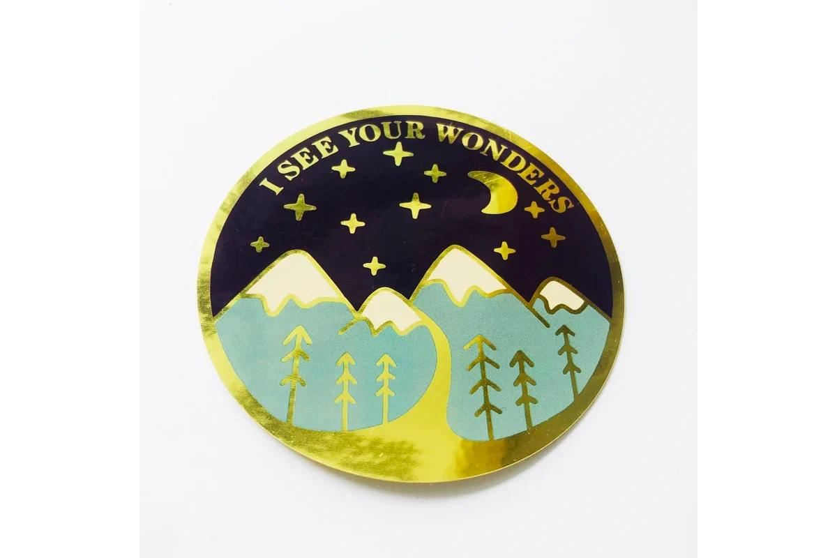 A printed round sticker with a gold metallic border