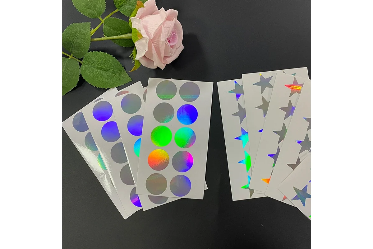 Holographic circle and star stickers arranged on backing sheets.