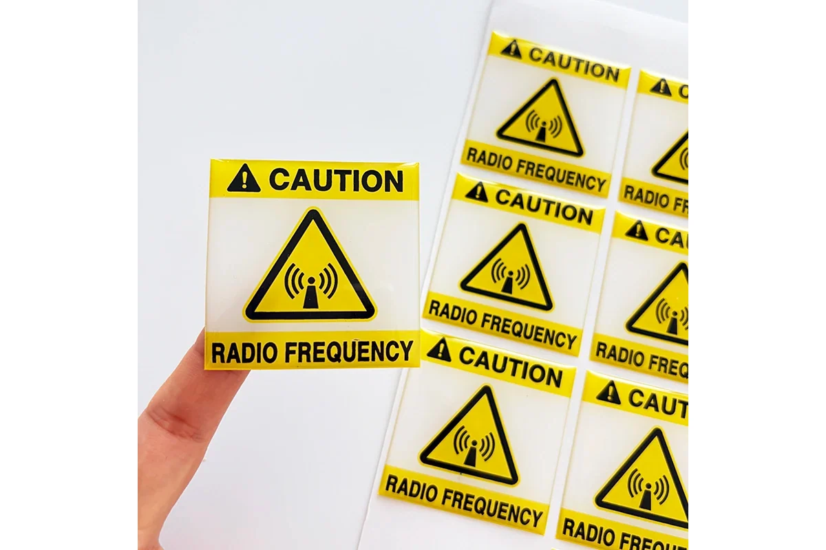 Yellow caution labels printed in rows on a sheet.