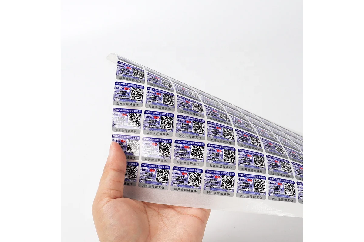 A flexible sheet of reflective QR security labels held in a hand.