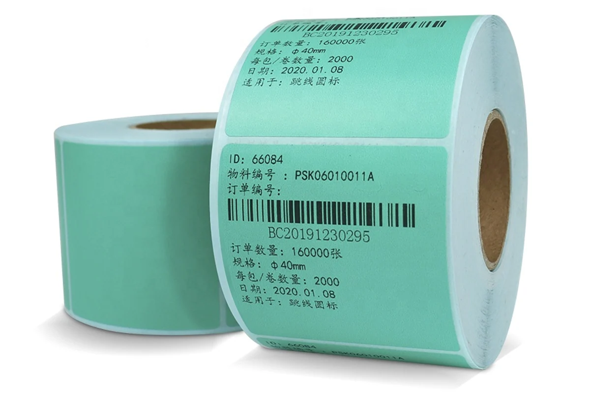 Two green barcode label rolls showing their printed labels and open cores.