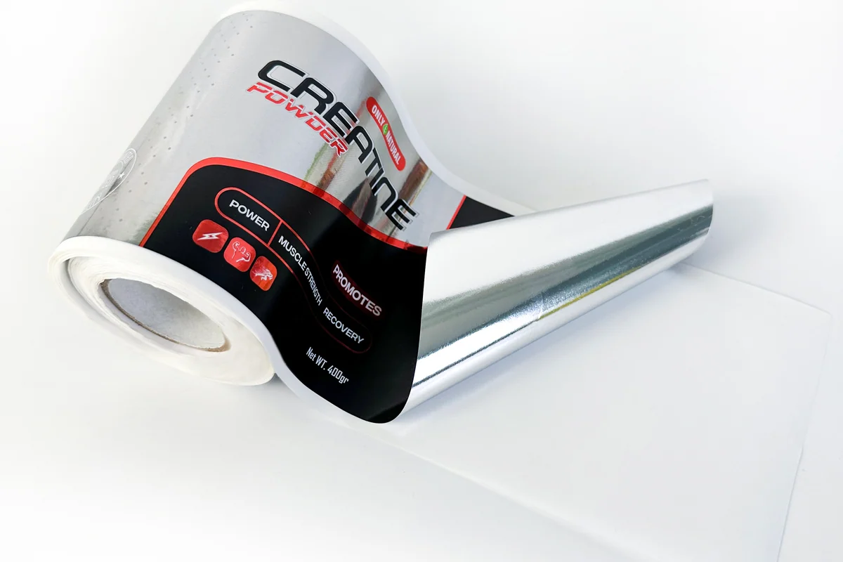 A reflective film label roll with a printed black design