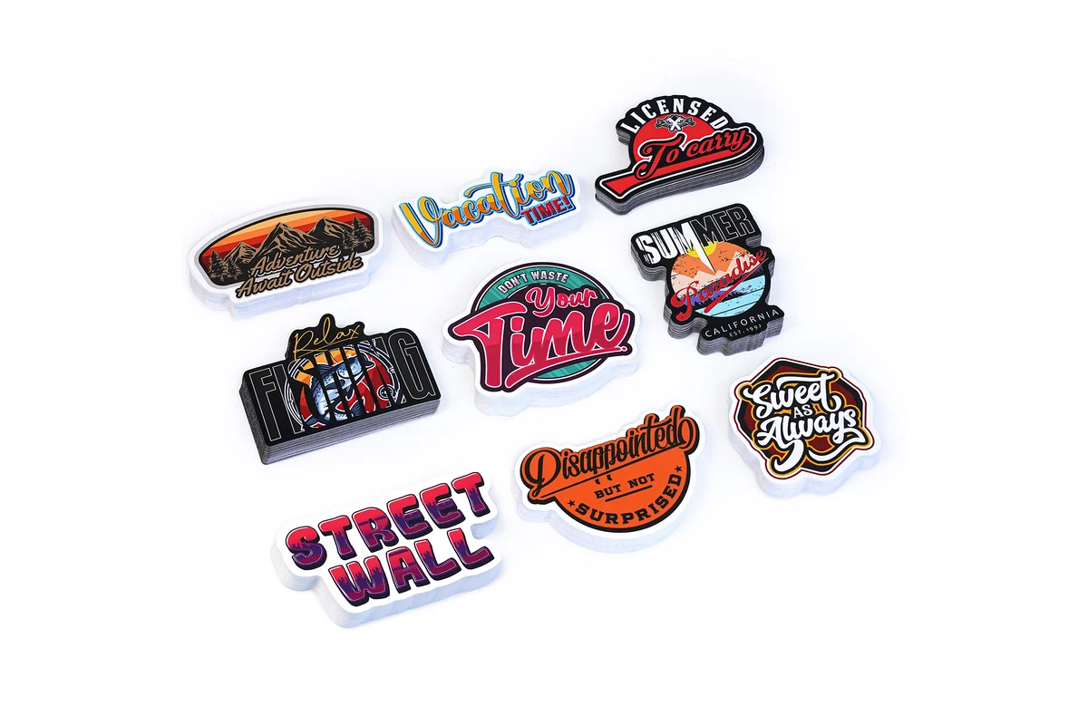 Individual printed stickers with colorful lettering and illustrations.