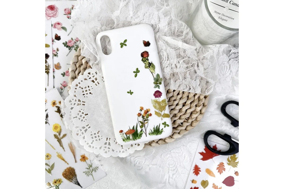 A white phone case decorated with fine floral transfer illustrations.