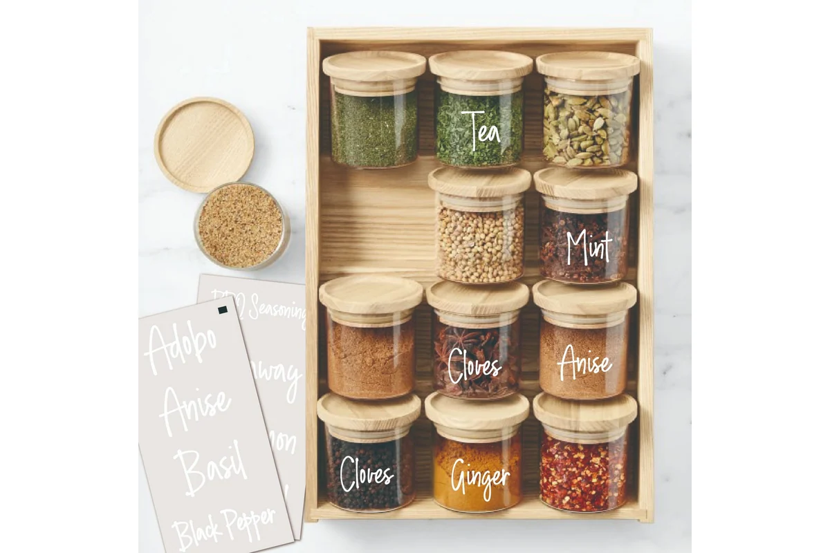 Glass storage jars decorated with white lettering transfers.