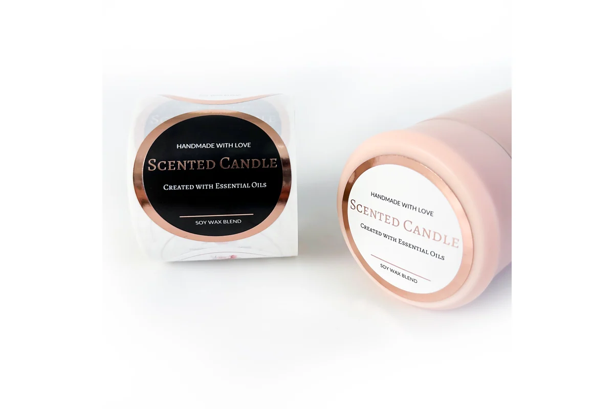 Black and pale pink round candle labels on rolls.