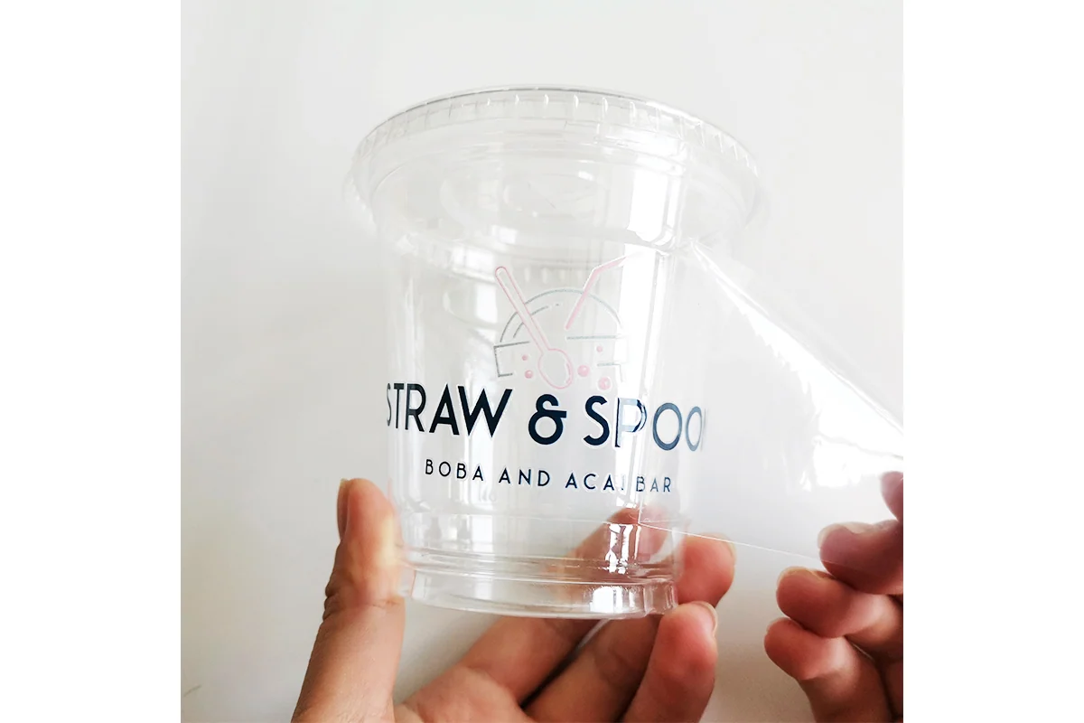 A clear printed label held against a transparent cup.